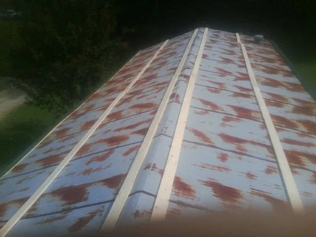 Rusted metal roof panels with new wood purlins before replacement — Storm Damage Roof Repair in Bantry by Roofing Brothers
